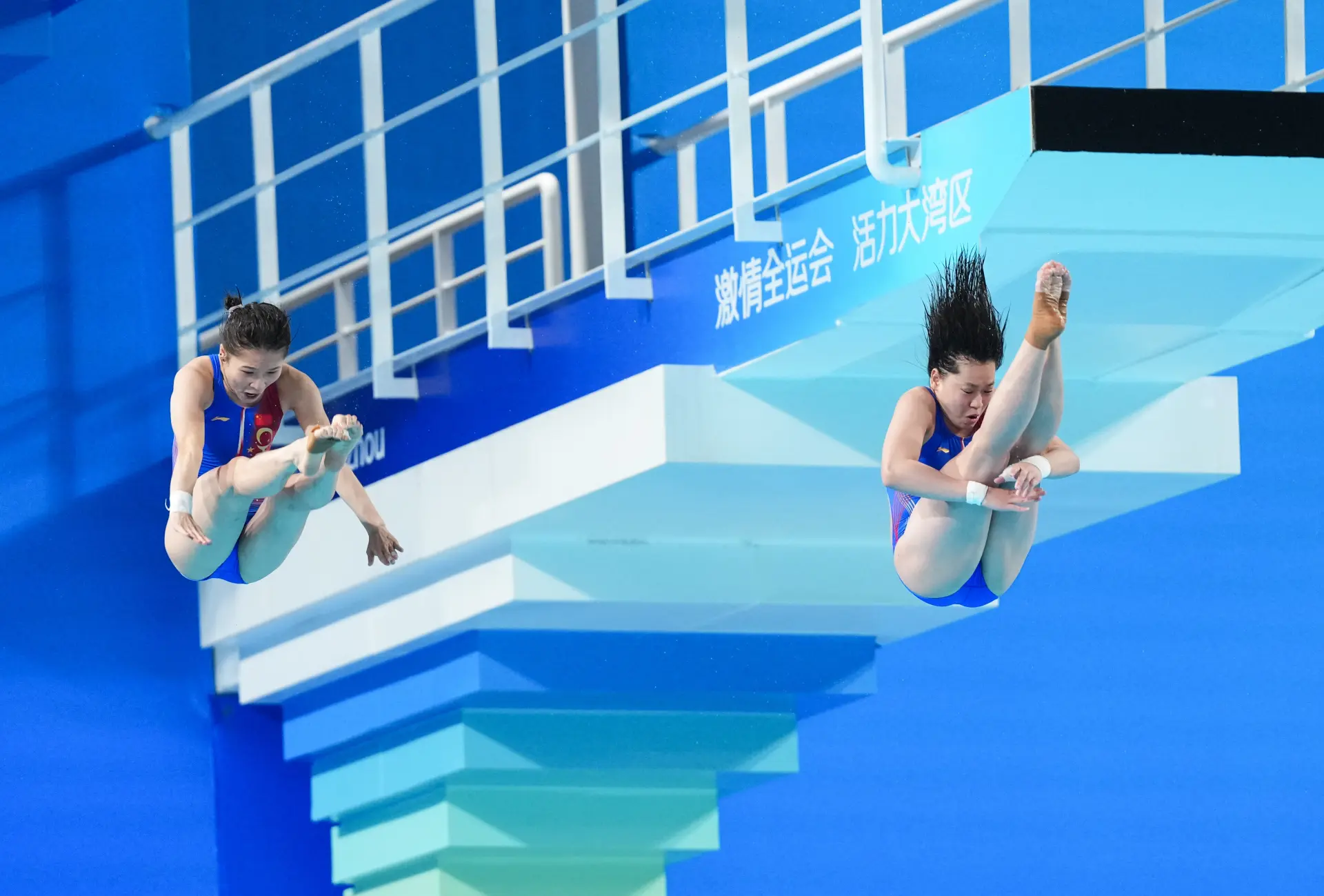 當晚壓軸登場的雙人 10 米台比賽中，她與 22 歲的新搭檔王偉瑩首跳便選擇難度系數 3.0 的 107B 動作，兩人起跳同步、空中姿態工整，入水時再度上演經典的「水花消失術」。(圖：新華社)