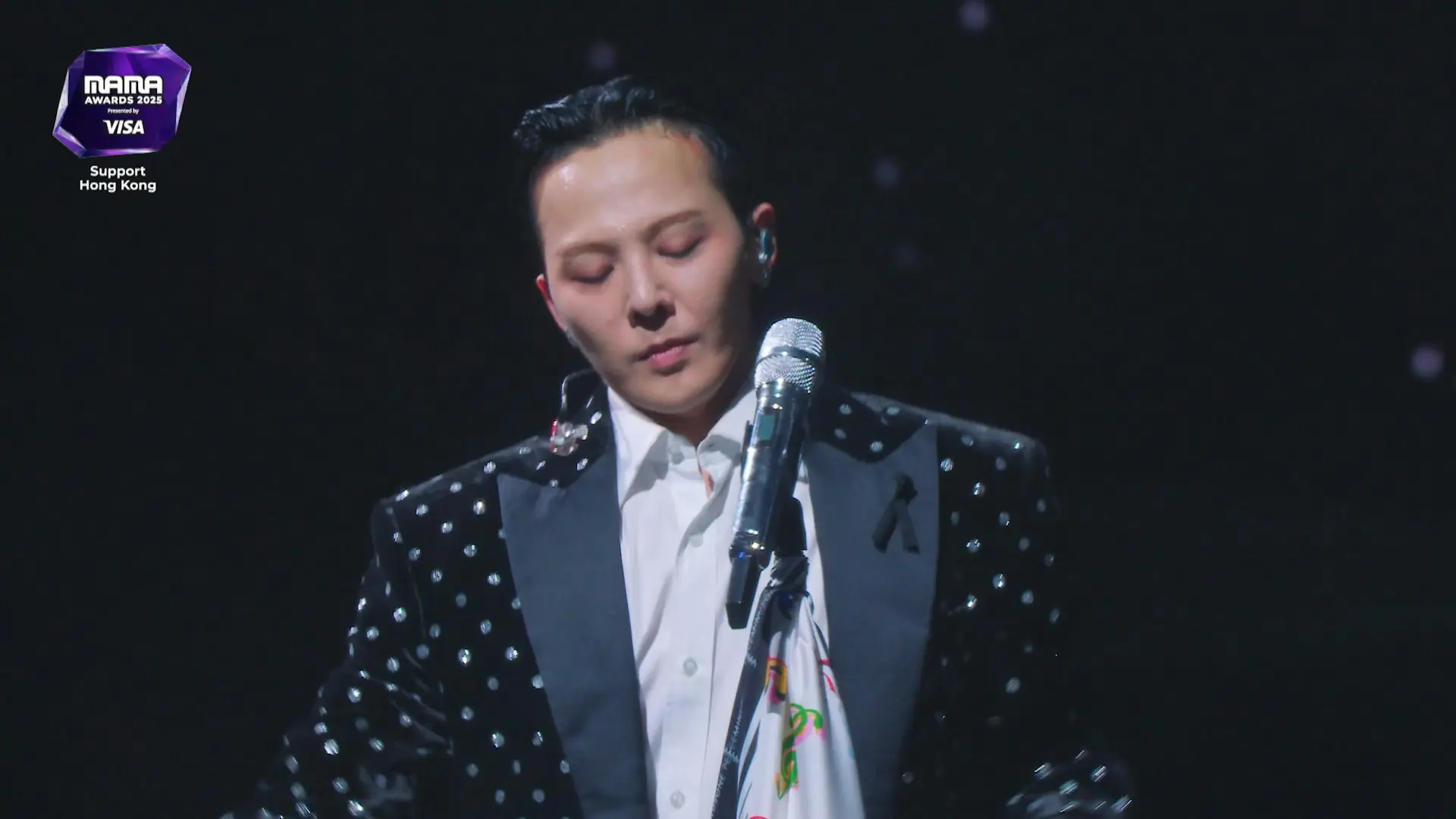 向來對演出品質要求嚴格的GD，在壓軸表演環節遭遇耳麥故障、收音中斷等狀況，現場鏡頭更捕捉到他頻頻摘下耳機確認、神情不耐的畫面，甚至有瞬間翻白眼的鏡頭，可見其心情大受影響。(圖：視頻截圖)