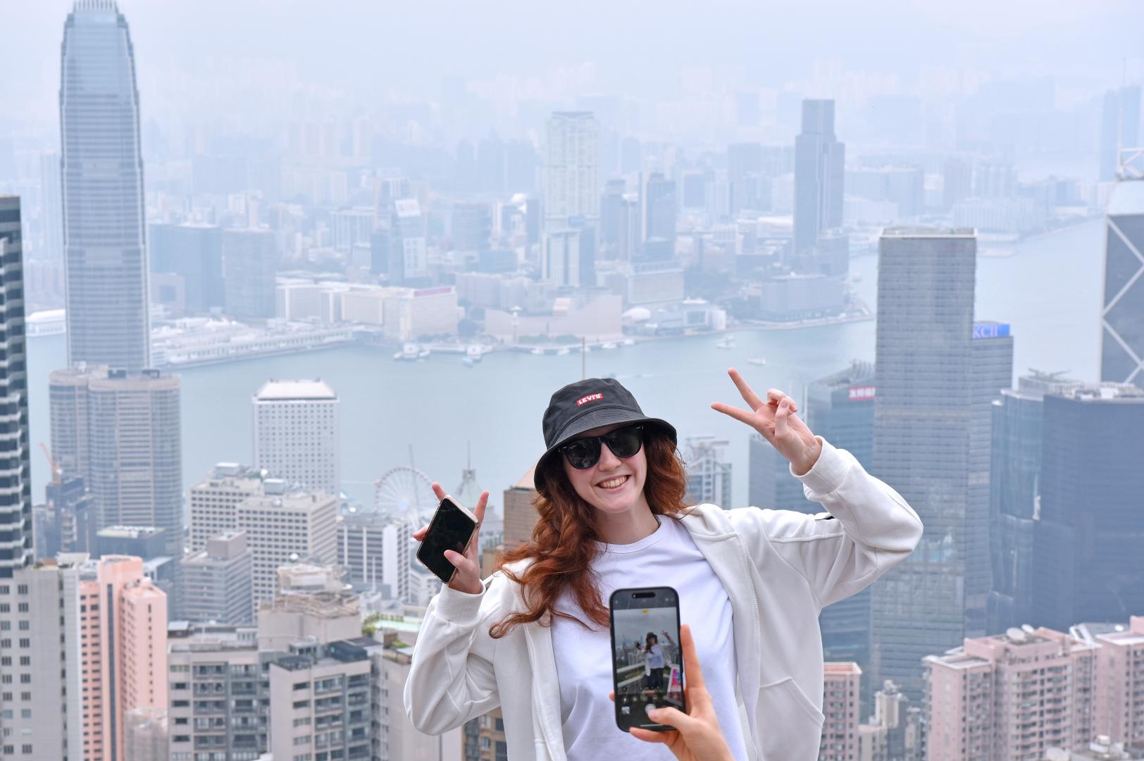 遊客在香港太平山頂獅子亭打卡拍照。(新華社)